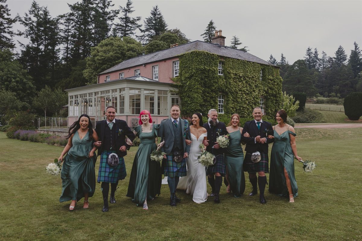 wedding party on the lawn in front of Ballogie House, Aberdeenshire exclusive use wedding venue