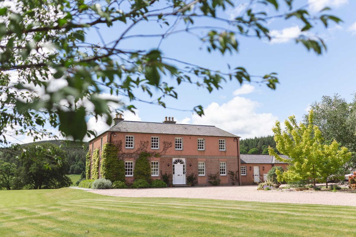 Ballogie House surrounded by greenery in Spring/Summer