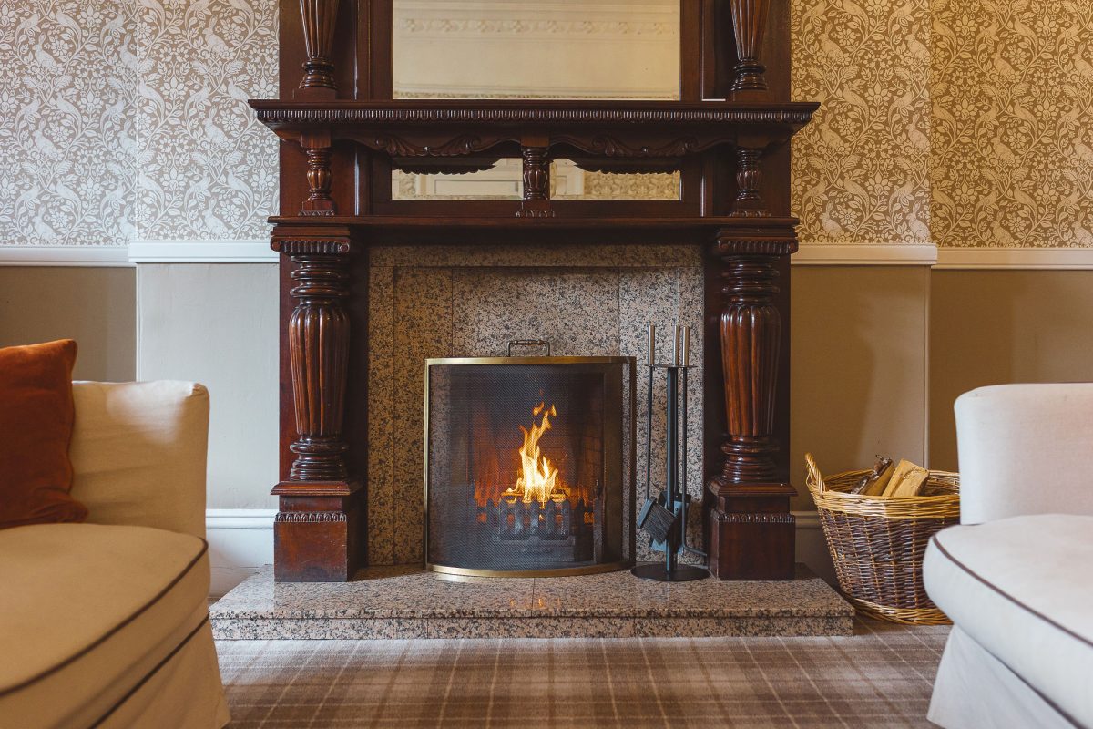 Cosy separate lounge at Potarch Lodge with open fire