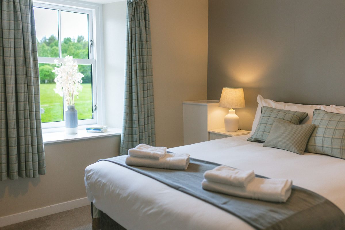 Comfortable king bedroom at Potarch Lodge with ensuite bathroom