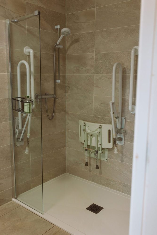 Accessible shower with support rails in the ground floor bedroom ensuite bathroom