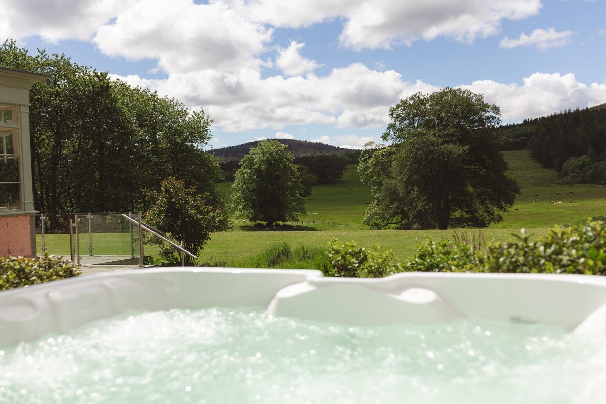 Ballogie House hot tub on the patio area, with sweeping views across the open parkland