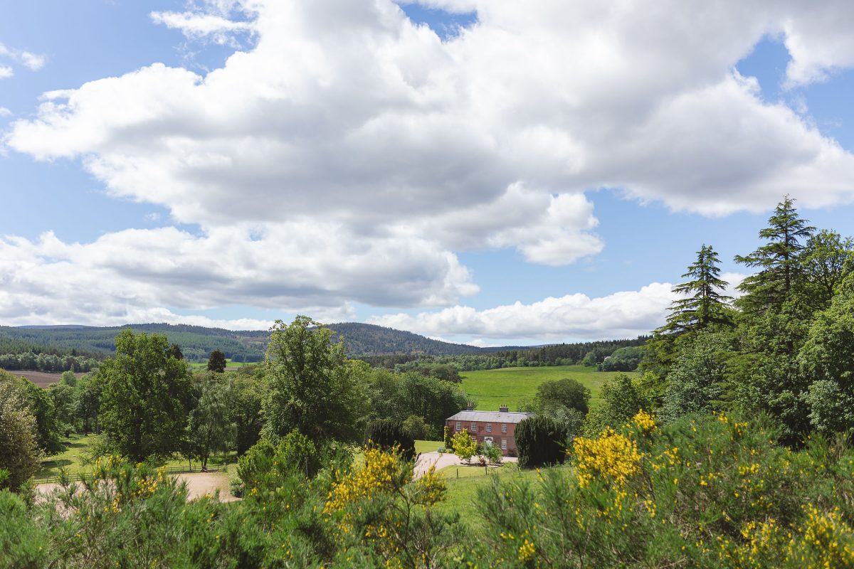 Ballogie House hidden amongst by spring / summer greenery, set in a beautiful parkland with rolling hills and mature woodland